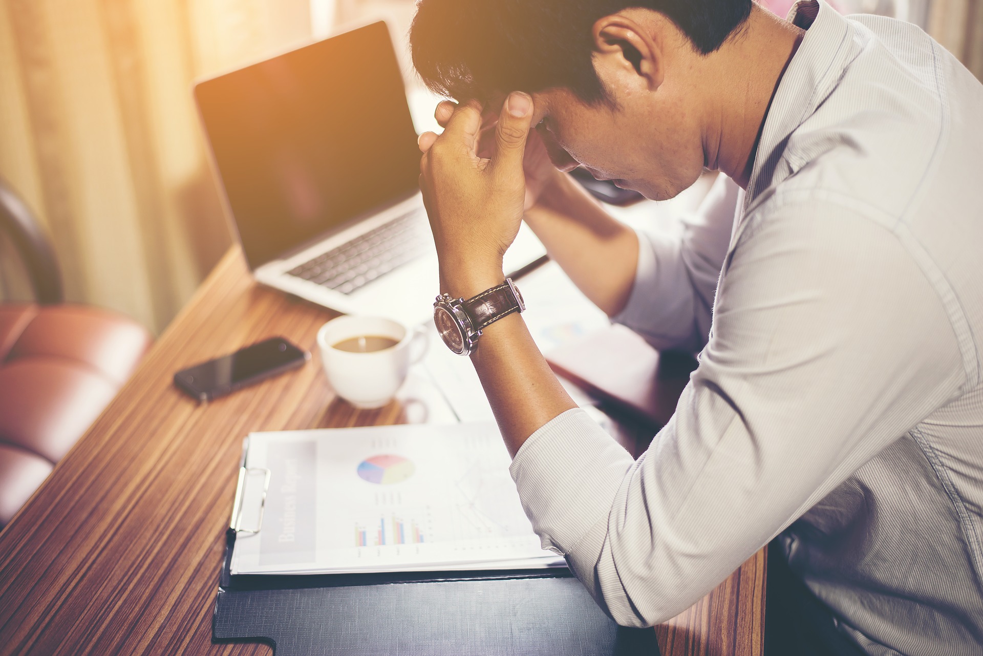 Stressed man looking at finances