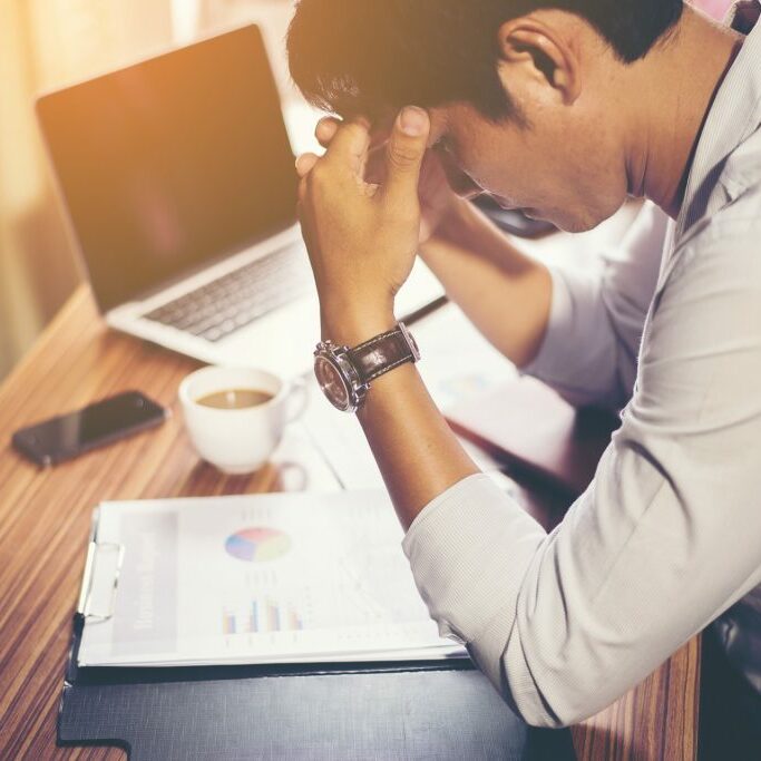 Stressed man looking at finances
